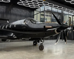 Pilatus PC-12 parked in a hangar with a multi-blade MT-Propeller