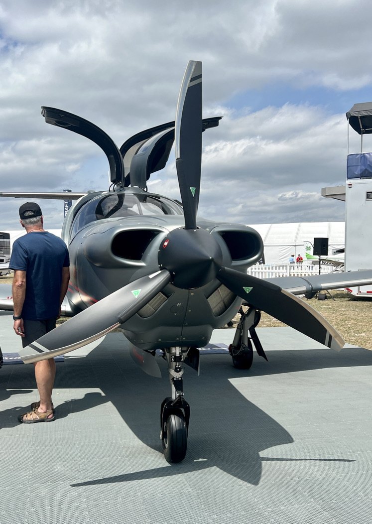 Gray Diamond aircraft with a four-blade MT propeller at an airshow