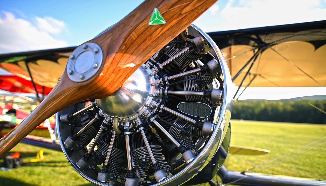 Close-up of a wooden MT propeller in front of a radial engine on a biplane